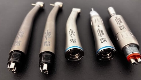 Collection of ADAE Dental handpieces and accessories, including high-speed and low-speed dental handpieces, contra angles, air motors, and replacement parts for professional dental use.